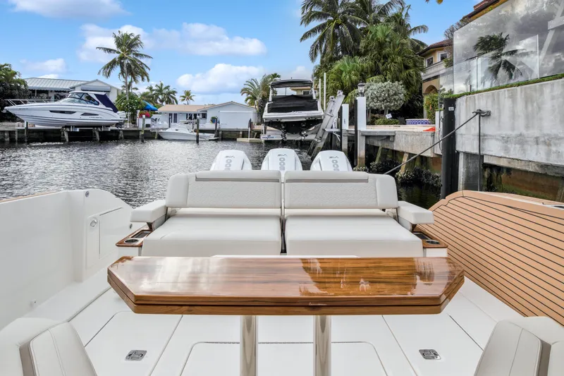  Yacht Photos Pics 2022 Tiara Yachts 48 LS luxury boat with elegant seating and waterfront view.