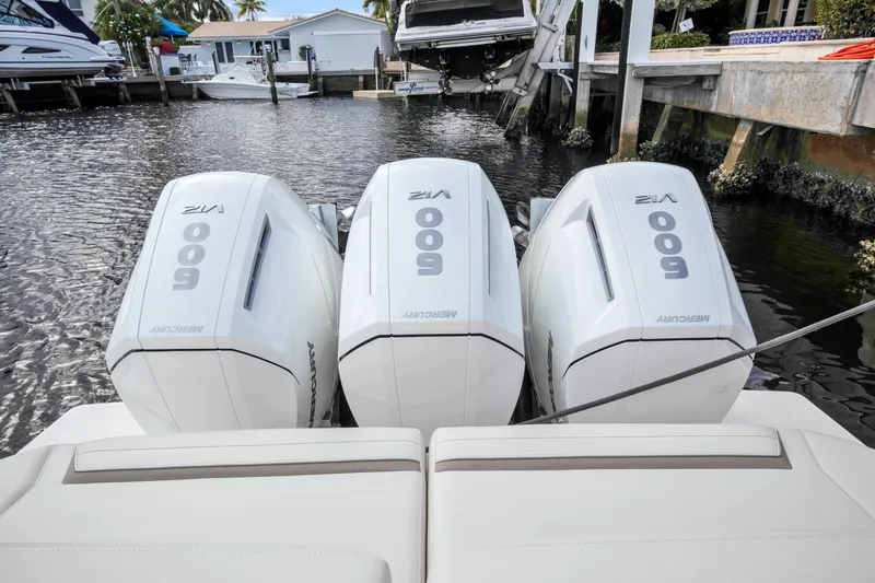  Yacht Photos Pics 2022 Tiara Yachts 48 LS with triple Mercury 600 outboard engines docked in marina.