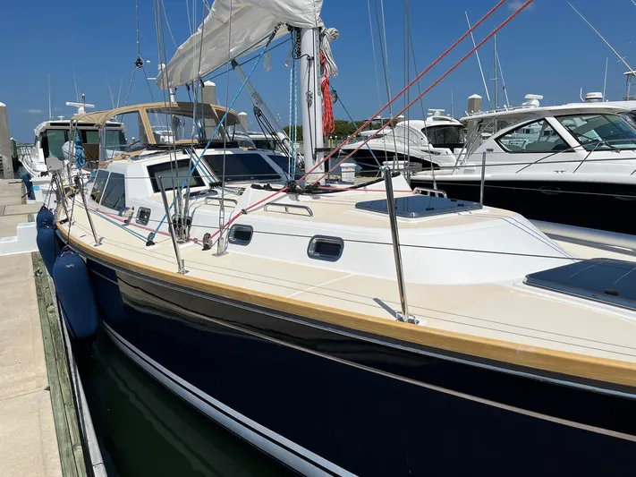 Sapphire Yacht Photos Pics 2014 Tartan 4700 sailboat docked at marina on a sunny day.