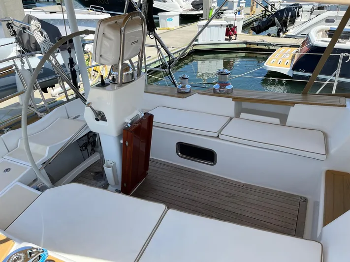 Sapphire Yacht Photos Pics Cockpit of 2014 Tartan 4700 sailboat with white cushioned seating and steering wheel.