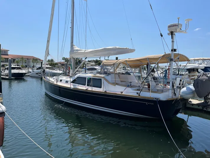 Sapphire Yacht Photos Pics 2014 Tartan 4700 sailboat docked at a marina on a sunny day.