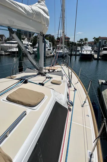 Sapphire Yacht Photos Pics 2014 Tartan 4700 sailboat docked at a marina with other boats in the background.