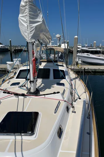 Sapphire Yacht Photos Pics 2014 Tartan 4700 sailboat docked at a marina on a sunny day.