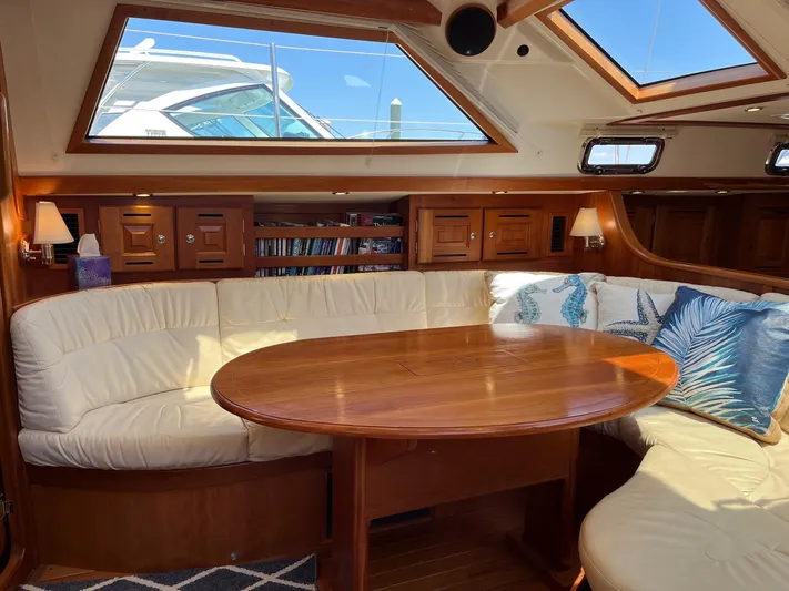 Sapphire Yacht Photos Pics Luxurious 2014 Tartan 4700 yacht interior with plush seating and wooden table.