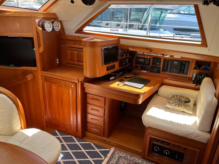 Sapphire Yacht Photos Pics Luxurious interior of 2014 Tartan 4700 yacht with navigation station and wooden cabinetry.