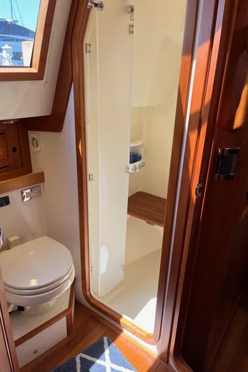 Sapphire Yacht Photos Pics 2014 Tartan 4700 yacht bathroom with wooden accents and shower area.