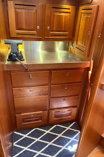 Sapphire Yacht Photos Pics 2014 Tartan 4700 yacht interior with wooden cabinetry and stainless steel countertop.