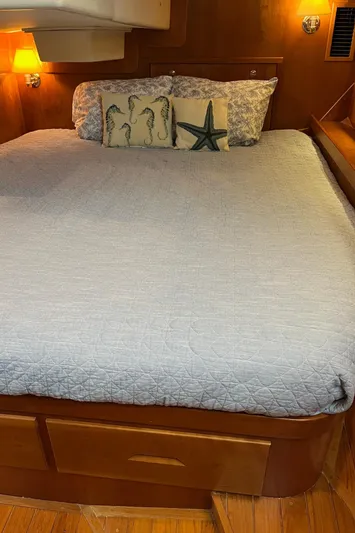 Sapphire Yacht Photos Pics 2014 Tartan 4700 yacht bedroom with cozy bedding and nautical-themed pillows.