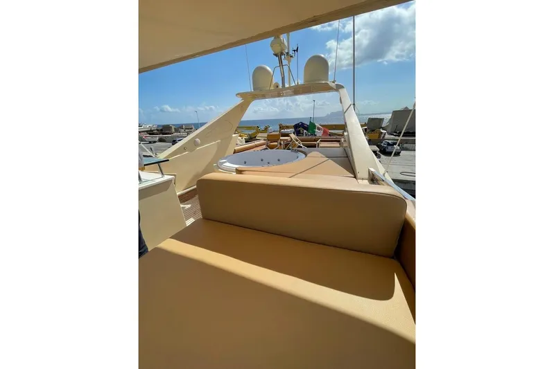 Andea Yacht Photos Pics Luxurious 2008 Tecnomar Nadara 26 Fly yacht deck with seating, under clear blue sky.