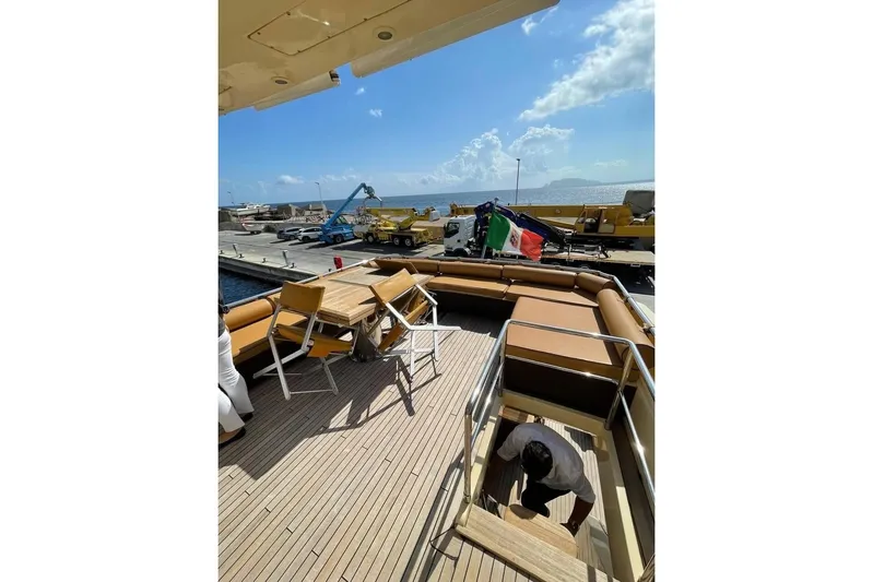 Andea Yacht Photos Pics Deck view of 2008 Tecnomar Nadara 26 Fly yacht at dockside with seating and table.