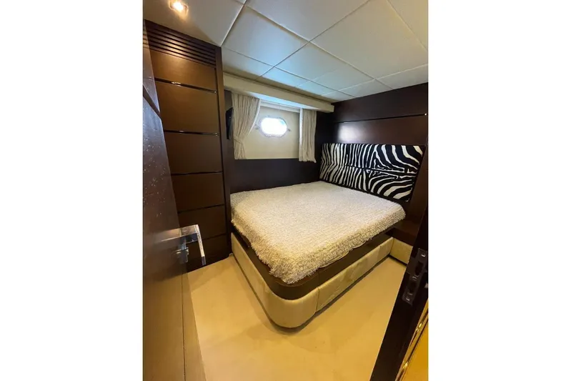 Andea Yacht Photos Pics Luxurious bedroom interior of 2008 Tecnomar Nadara 26 Fly yacht with zebra-patterned headboard.