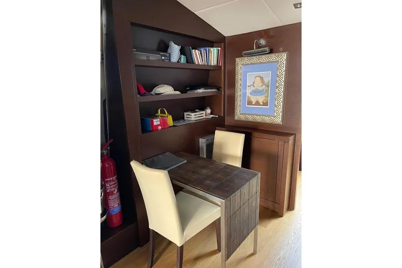 Andea Yacht Photos Pics Interior of 2008 Tecnomar Nadara 26 Fly yacht with desk, chair, shelves, and artwork.