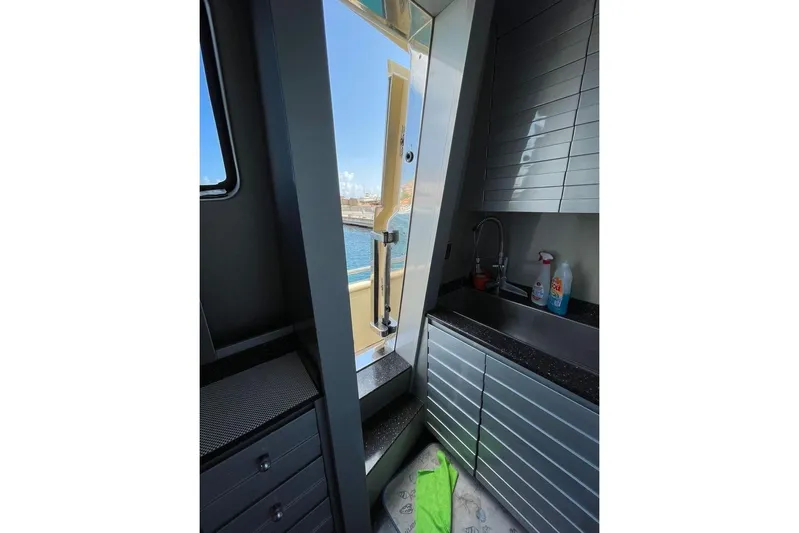 Andea Yacht Photos Pics Interior view of Tecnomar Nadara 26 Fly yacht, featuring modern kitchen and ocean view.