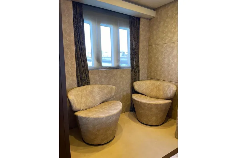 Andea Yacht Photos Pics Luxurious seating area on 2008 Tecnomar Nadara 26 Fly yacht with elegant chairs and window.