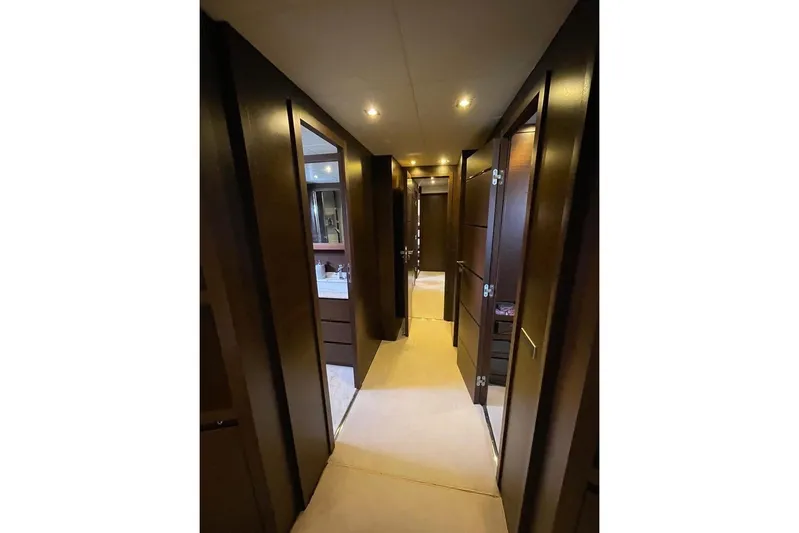 Andea Yacht Photos Pics Luxurious hallway interior of 2008 Tecnomar Nadara 26 Fly yacht with elegant wood finishes.