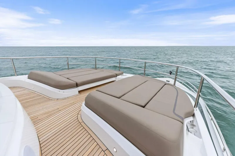 Amarula Sun Yacht Photos Pics Luxurious 2024 Princess X80 yacht deck with sun loungers overlooking the ocean.