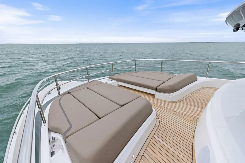 Amarula Sun Yacht Photos Pics Luxurious 2024 Princess X80 yacht deck with sun loungers overlooking the ocean.