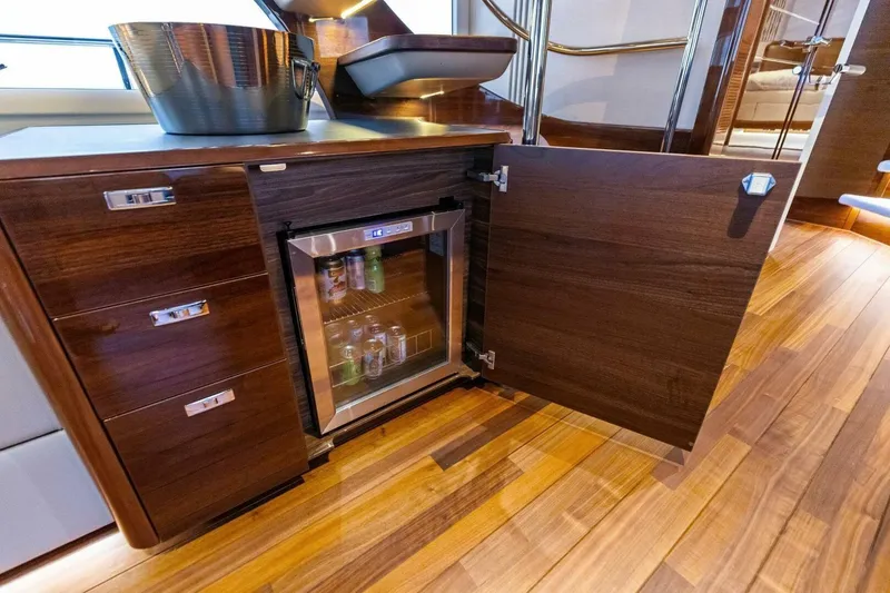 Amarula Sun Yacht Photos Pics Luxurious 2024 Princess X80 yacht interior with minibar and elegant wood finish.