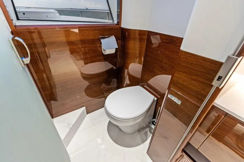 Amarula Sun Yacht Photos Pics Luxurious bathroom in 2024 Princess X80 yacht with wooden paneling and modern fixtures.