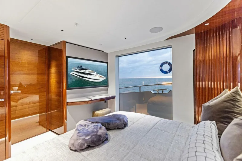 Amarula Sun Yacht Photos Pics Luxurious 2024 Princess X80 yacht bedroom with ocean view and elegant wood finishes.