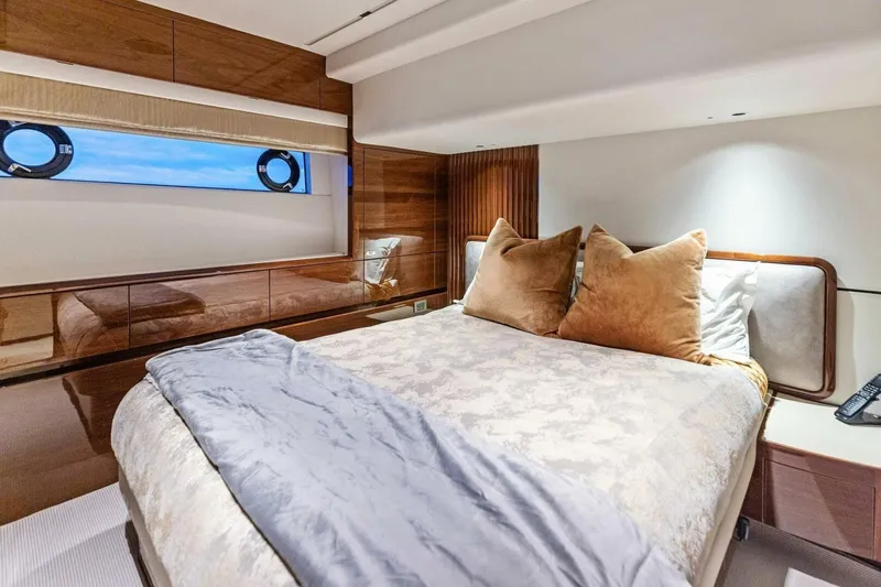 Amarula Sun Yacht Photos Pics Luxurious bedroom interior of 2024 Princess X80 yacht with elegant bedding and wood accents.