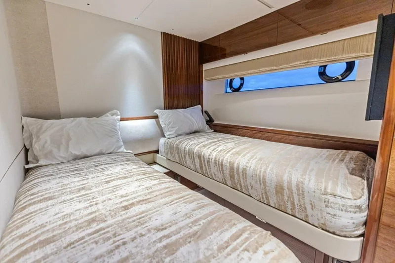 Amarula Sun Yacht Photos Pics Luxurious twin cabin interior of 2024 Princess X80 yacht with elegant bedding and wood accents.