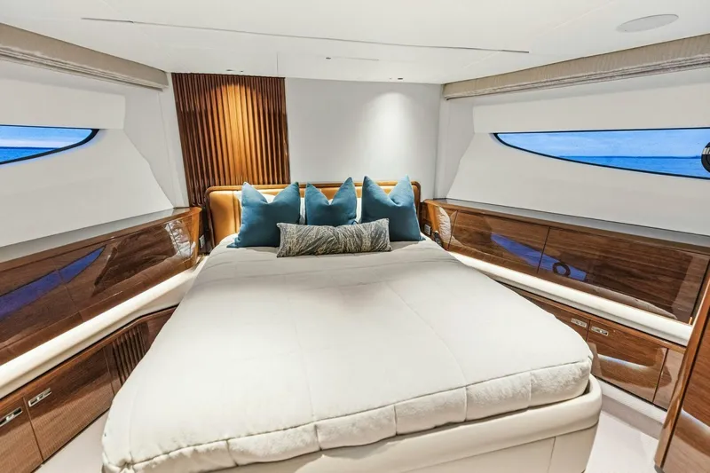 Amarula Sun Yacht Photos Pics Luxurious bedroom interior of 2024 Princess X80 yacht with elegant wood finishes and ocean view.