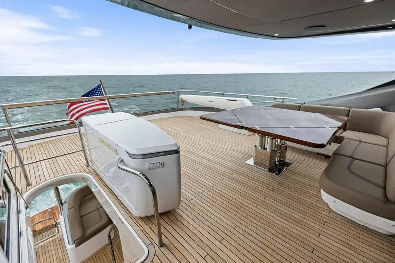 Amarula Sun Yacht Photos Pics Luxurious 2024 Princess X80 yacht deck with seating, table, and ocean view.
