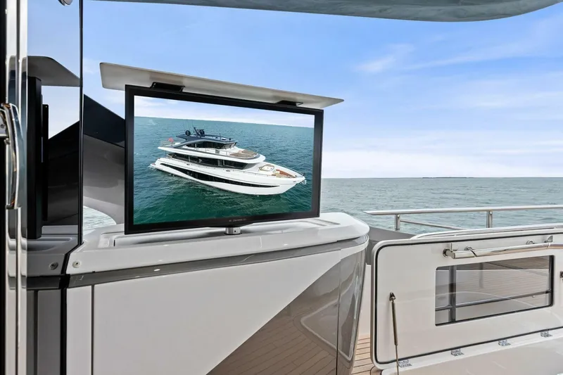 Amarula Sun Yacht Photos Pics 2024 Princess X80 yacht with outdoor TV displaying yacht image, ocean view.