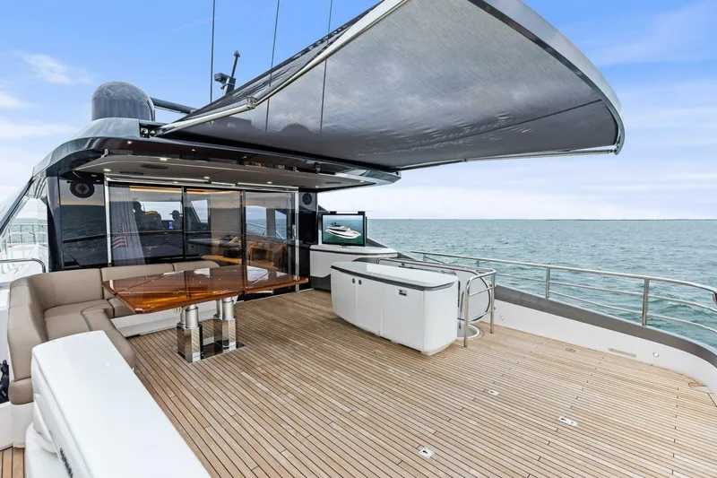 Amarula Sun Yacht Photos Pics Luxurious 2024 Princess X80 yacht deck with seating, table, and ocean view.