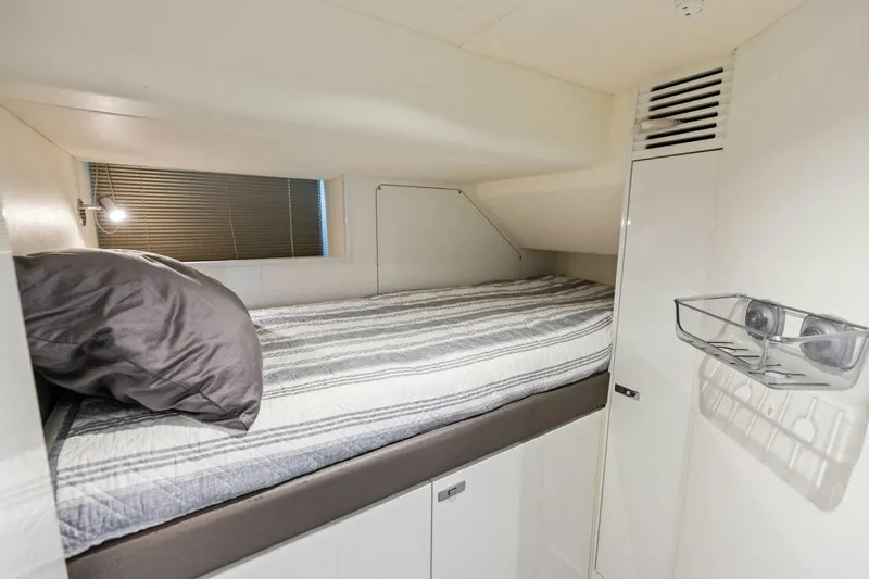 Amarula Sun Yacht Photos Pics Cozy cabin bed in 2024 Princess X80 yacht, featuring modern design and striped bedding.