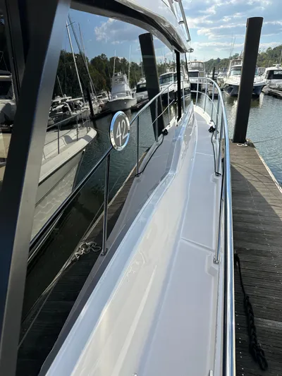 Vinovoyager Yacht Photos Pics 2021 Regal 42 FXO yacht docked at marina, side view.