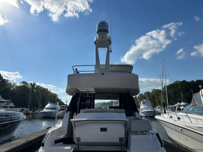Vinovoyager Yacht Photos Pics 2021 Regal 42 FXO yacht docked at marina under clear blue sky.