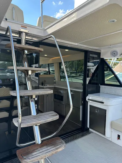 Vinovoyager Yacht Photos Pics 2021 Regal 42 FXO yacht interior with modern kitchen and spiral staircase.