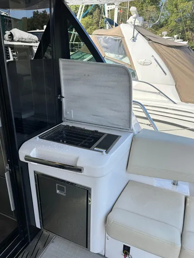 Vinovoyager Yacht Photos Pics 2021 Regal 42 FXO yacht with outdoor kitchenette and seating area.