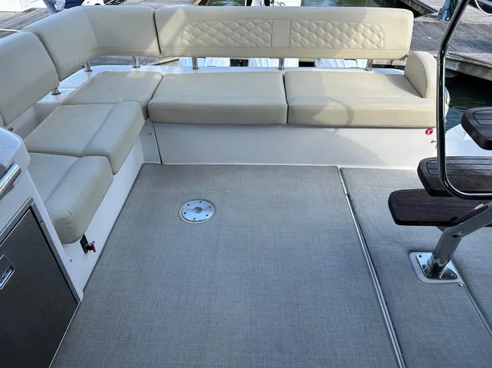 Vinovoyager Yacht Photos Pics Luxurious seating area on 2021 Regal 42 FXO yacht, featuring beige upholstery and spacious layout.