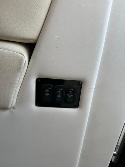 Vinovoyager Yacht Photos Pics 2021 Regal 42 FXO interior with control panel on white upholstery.