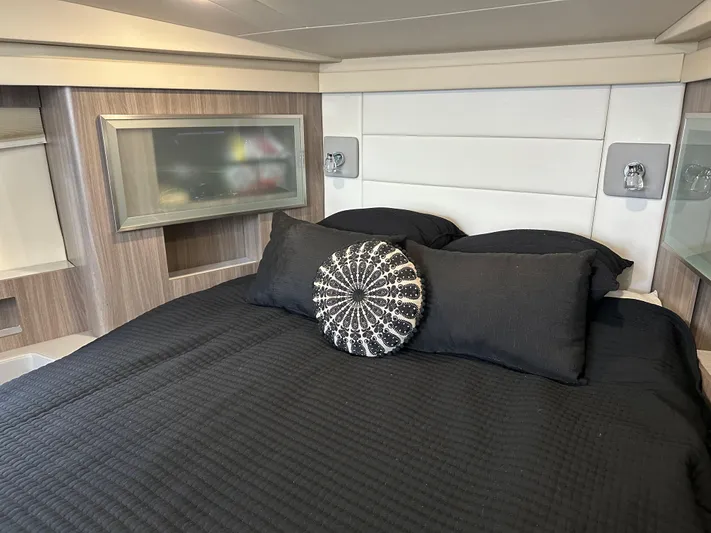 Vinovoyager Yacht Photos Pics Luxurious bedroom interior of 2021 Regal 42 FXO yacht with modern design and black bedding.