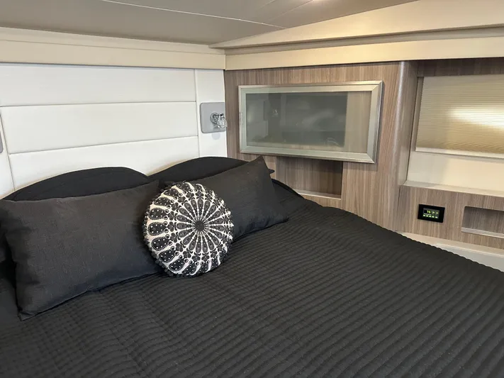 Vinovoyager Yacht Photos Pics Luxurious cabin interior of 2021 Regal 42 FXO yacht with modern bedding.