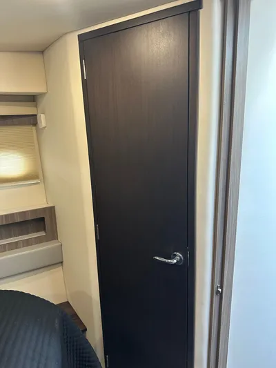 Vinovoyager Yacht Photos Pics Interior of 2021 Regal 42 FXO yacht, featuring a sleek wooden door.