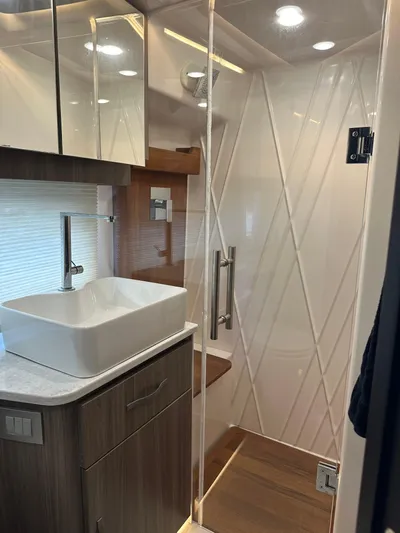 Vinovoyager Yacht Photos Pics Modern bathroom interior in 2021 Regal 42 FXO yacht with sleek design and glass shower.