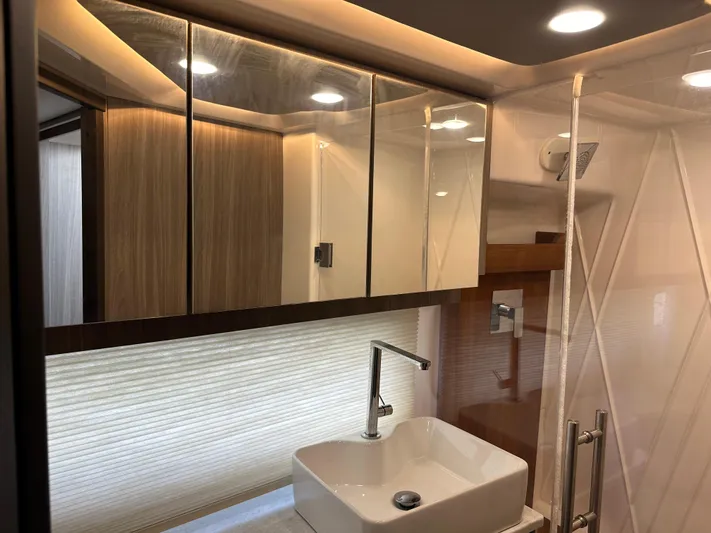 Vinovoyager Yacht Photos Pics Luxurious bathroom interior of 2021 Regal 42 FXO yacht with modern fixtures and lighting.