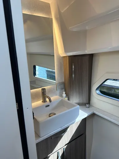 Vinovoyager Yacht Photos Pics 2021 Regal 42 FXO yacht bathroom with modern sink and window.