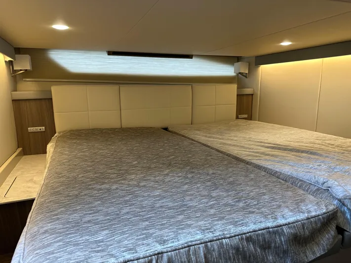 Vinovoyager Yacht Photos Pics Interior cabin of 2021 Regal 42 FXO yacht with modern bedding and ambient lighting.