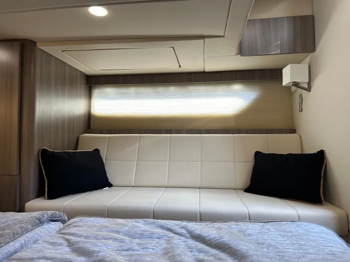 Vinovoyager Yacht Photos Pics Interior of 2021 Regal 42 FXO yacht with modern sofa and bedding.