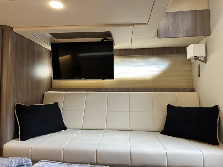 Vinovoyager Yacht Photos Pics Interior of 2021 Regal 42 FXO yacht with modern sofa and wall-mounted TV.