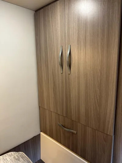 Vinovoyager Yacht Photos Pics Wooden cabinet interior of 2021 Regal 42 FXO yacht, featuring sleek handles.