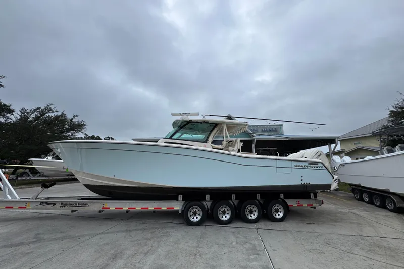  Yacht Photos Pics 2024 Grady-White Canyon 386 boat on trailer, overcast sky background.