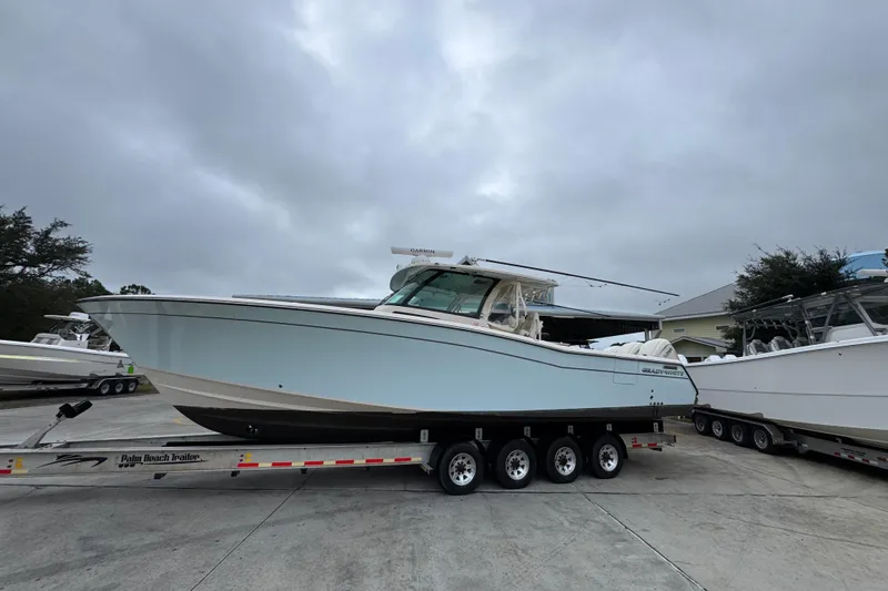  Yacht Photos Pics 2024 Grady-White Canyon 386 boat on trailer under cloudy sky.