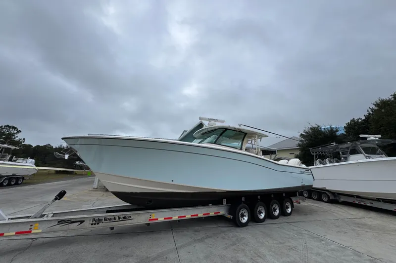  Yacht Photos Pics 2024 Grady-White Canyon 386 boat on trailer under cloudy sky.